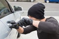 Thief breaking into car with screwdriver Royalty Free Stock Photo