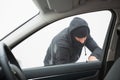 Thief breaking into car with screwdriver Royalty Free Stock Photo