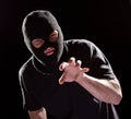 Thief Burglar in Mask Grabbing by Hand. Crime Man in Black