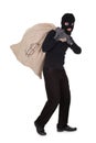 Thief carrying a large bag of money Royalty Free Stock Photo