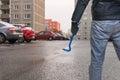 Thief with crowbar is going to steal car from parking lot Royalty Free Stock Photo