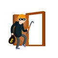 Thief with crowbar. Masked robber in black clothes broke down door of house