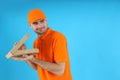 Thief delivery man with pizza on blue background