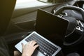 Thief hacking car system with laptop inside vehicle, closeup Royalty Free Stock Photo