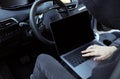 Thief hacking car system with laptop inside vehicle, closeup Royalty Free Stock Photo