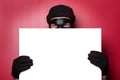 Thief hiding behind advert Royalty Free Stock Photo