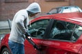 Thief Using Crowbar To Open Car`s Door