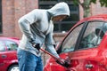 Thief Using Crowbar To Open Car`s Door