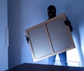 Thief inside home stealing a painting