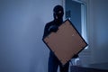 Thief inside home stealing a painting Royalty Free Stock Photo