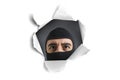 Thief looking through a paper hole Royalty Free Stock Photo