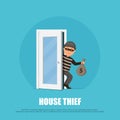 Thief in a mask holding a money bag and sneaks through the door. Cartoon burglar in flat style. Royalty Free Stock Photo