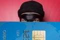 Thief smiling with big blue credit card Royalty Free Stock Photo