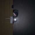 Thief sneaking through door Royalty Free Stock Photo