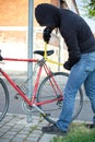 Thief stealing a bike in the city street Royalty Free Stock Photo