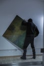 Thief stealing expensive painting