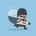 Thief stealing idea bulb and carrying on his back Royalty Free Stock Photo