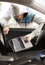 Thief stealing laptop from the car Royalty Free Stock Photo