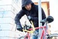 Thief stealing a bike in the city street Royalty Free Stock Photo