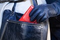 Thief stealing a purse from a woman's handbag Royalty Free Stock Photo