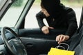 Thief stealing shopping bag from the car Royalty Free Stock Photo