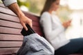 Thief Stealing Wallet From Girl`s Bag In Park, Cropped, Closeup Royalty Free Stock Photo