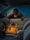 Thief stealing women handbag from car Royalty Free Stock Photo