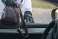 The thief steals a bag with documents through a window of the car, left by the owner Royalty Free Stock Photo