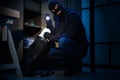 Thief taking money out of steel safe indoors Royalty Free Stock Photo