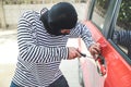 Thief try to break into car with screwdriver theft concept Royalty Free Stock Photo