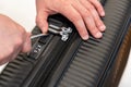 Thief trying to open locked suitcase with a screwdriver