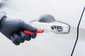 The thief uses a screwdriver Stealing a car at the door handle. The vehicle insurance concept Royalty Free Stock Photo