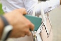 A man steals a wallet from a womans bag close up Royalty Free Stock Photo