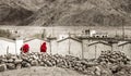 Thiksay Monastery in Thiksey village, India Ã¢â¬â August 20, 2016:Group tibetan monks in red robes goes by the colorless landscape Royalty Free Stock Photo