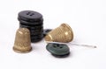 Thimble with a needle and black buttons