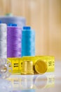 Thimbles and tapeline, spools on table Royalty Free Stock Photo
