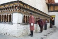 THIMPHU, BHUTAN - DEC 3, 2017: Pilgrims are spinning buddhist prayer wheels