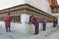 THIMPHU, BHUTAN - DEC 3, 2017: Pilgrims are spinning buddhist prayer wheels Royalty Free Stock Photo