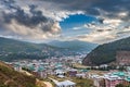 Thimphu, Bhutan - October 26, 2021: Aerial view cityscape of Bhutan capitol city. Top view with dramatic cloudy sky over the town