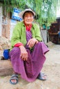 Thimphu, Bhutan - September 10, 2016: Elderly Bhutanese woman sitting in the street near street market.