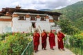 Thimphu, Bhutan - September 15, 2016: Four monks walking in the garden of Simtokha Dzong, Thimphu, Bhutan