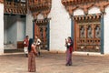 Thimphu, Bhutan - September 10, 2016: Local Bhutanese people wearing traditional clothing standing in the backyard of the temple.