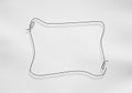A thin black wire is bent into a rectangular frame with rounded Royalty Free Stock Photo