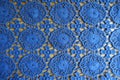 Thin blue lacy fabric on wood