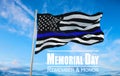 Thin Blue Line. Black Flag of USA with Police Blue Line waving in the wind on flagpole against the sky with clouds on sunny day Royalty Free Stock Photo