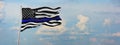 Thin Blue Line. Black Flag of USA with Police Blue Line waving in the wind on flagpole against the sky with clouds on sunny day. Royalty Free Stock Photo