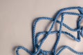 Thin blue rope on a light thunderstorm background