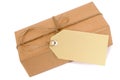 Thin brown paper package with string and gift tag or manila label isolated on white, copy space Royalty Free Stock Photo