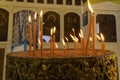 Lit candles on a church candelabrum. Royalty Free Stock Photo