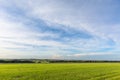 Thin clouds over green pastures Royalty Free Stock Photo